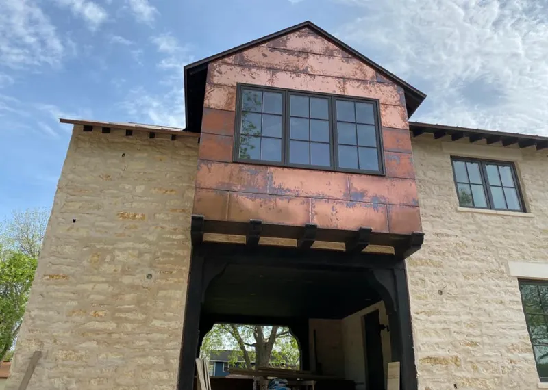 Copper metal panel facade on a stone building for Roof Repair in Prairie du Chien